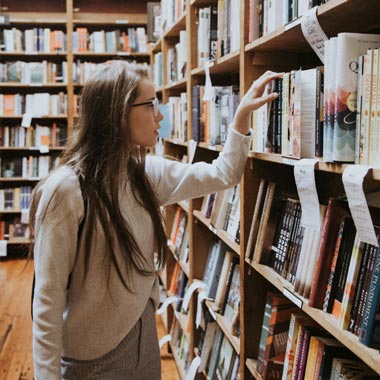 lady choosing a book at a bookstore